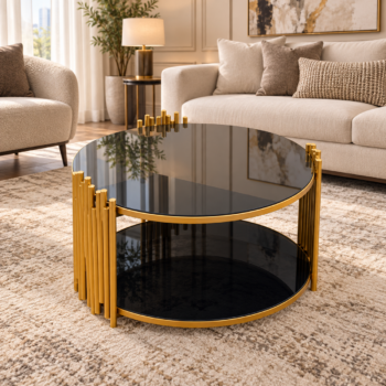 Modern round black tinted glass coffee table with vertical gold pipe accent frame and lower storage shelf in a living room